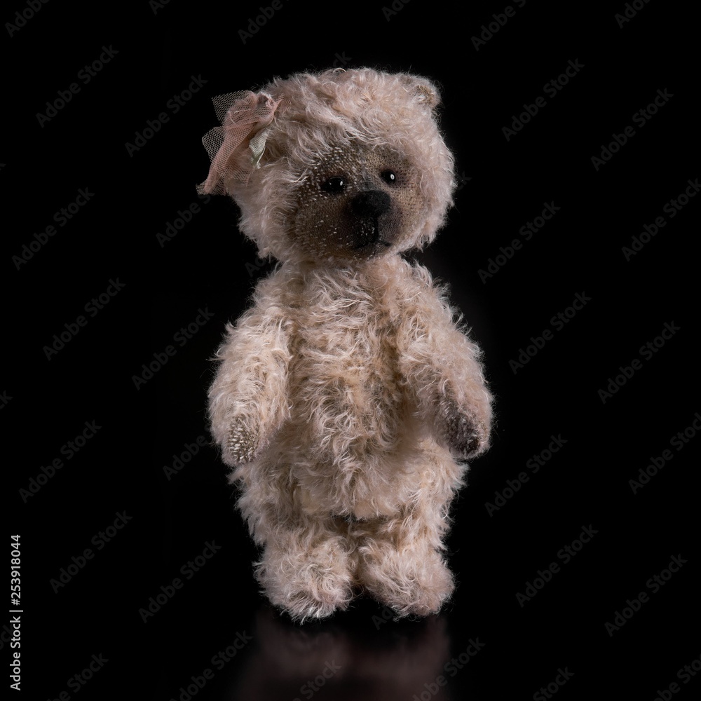Bear toy on a black background Bear toy on a black background