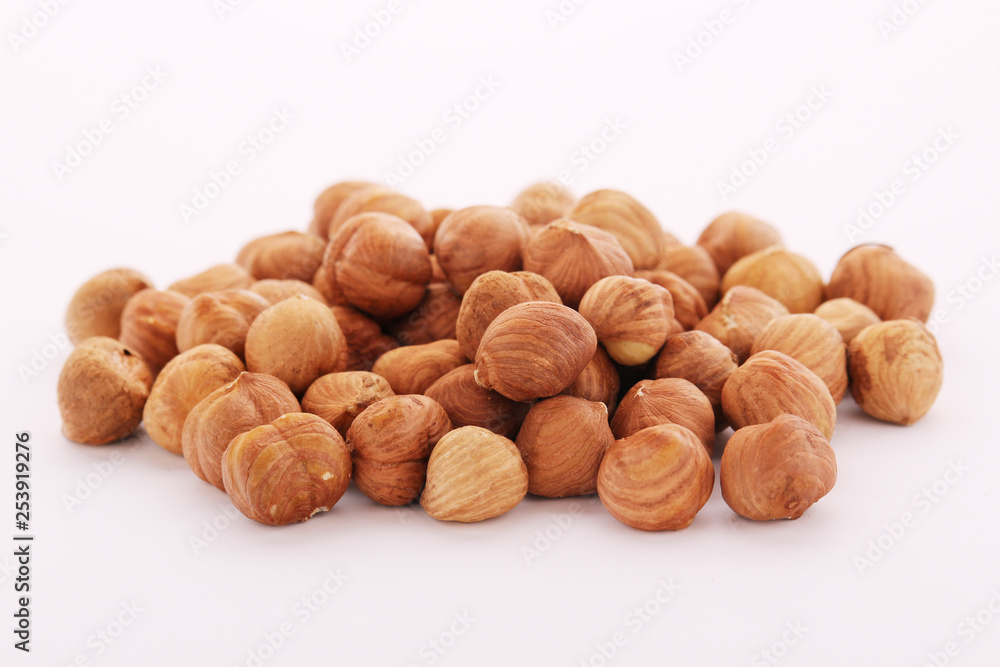 A pile of hazelnuts at white background A pile of hazelnuts at white background