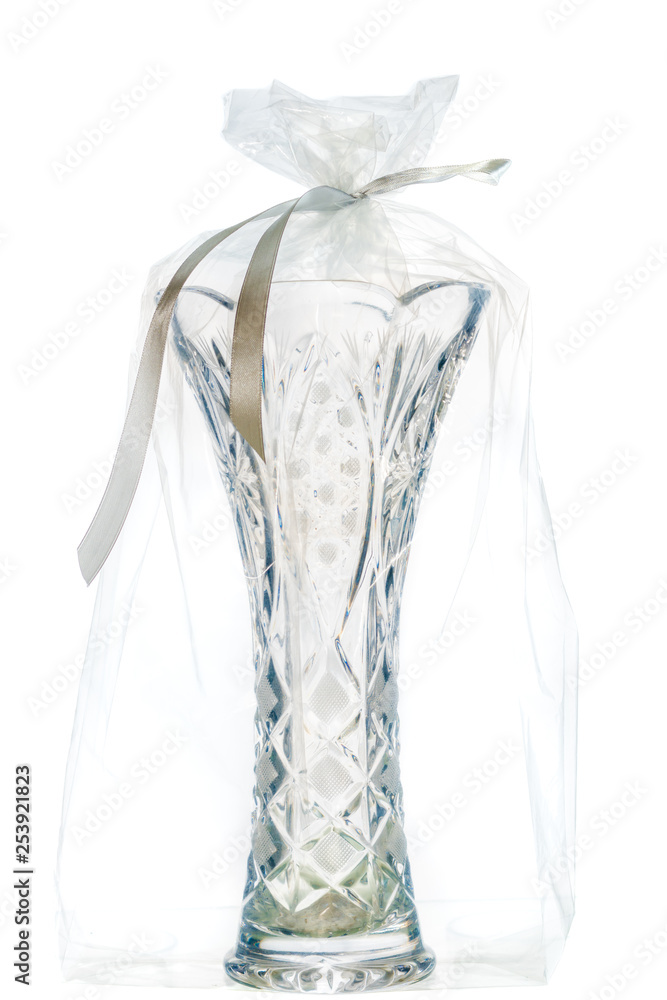 A bouquet of flowers from soap, a vase and a toy in a transparent packaging bag