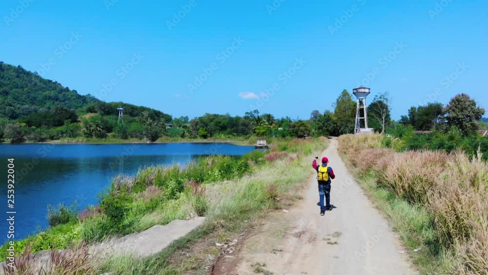 Travel with a small backpack on the great natural background of a beautiful lake. Travel with a small backpack on the great natural background of a beautiful lake.