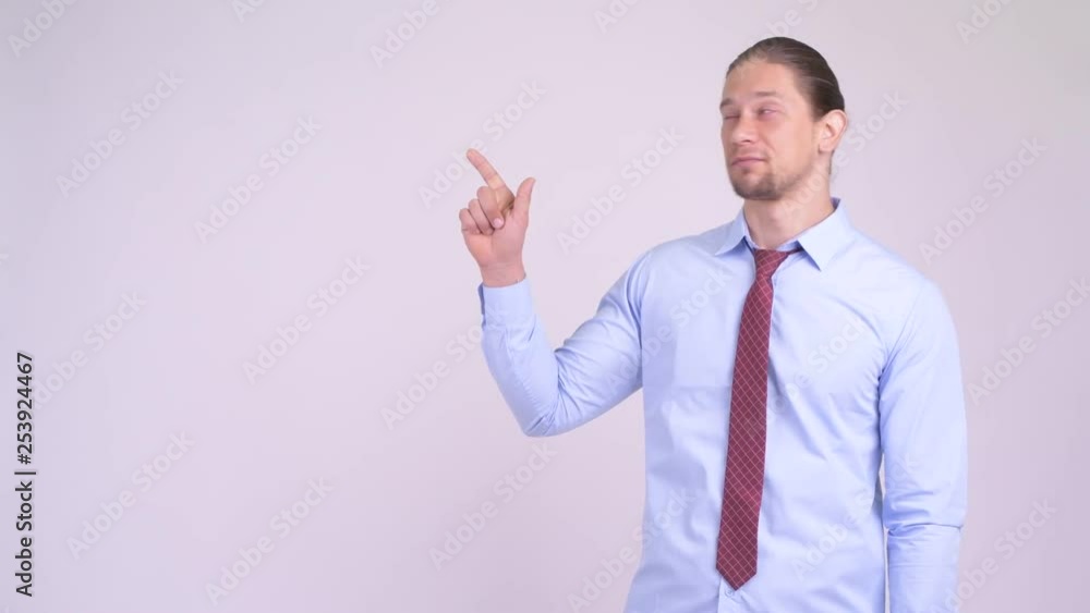 Happy handsome businessman thinking and pointing up Happy handsome businessman thinking and pointing up