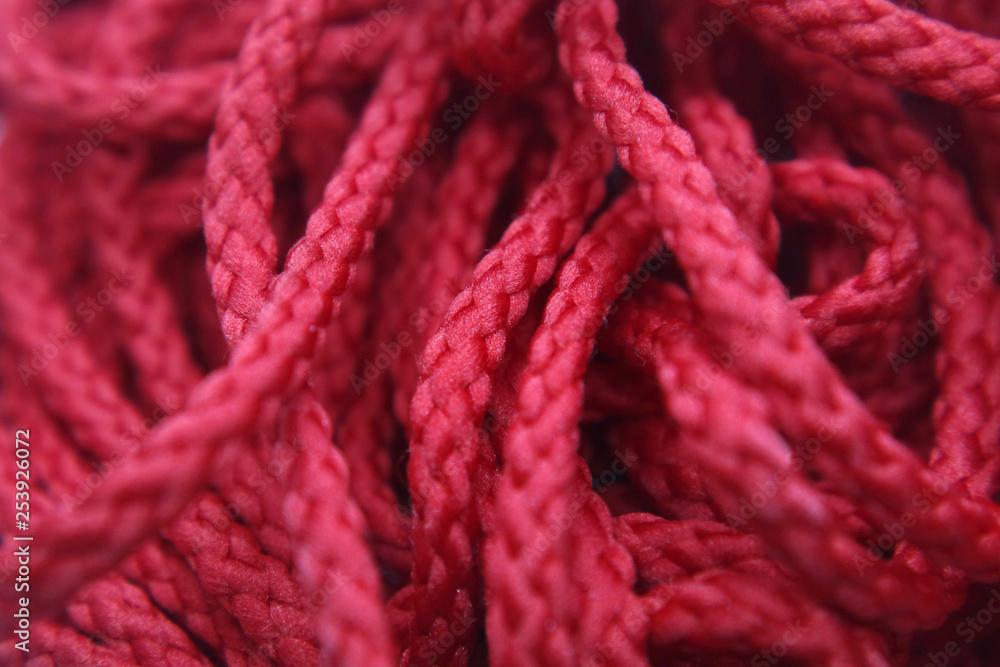 Lace red round braided Hank macro as background for design.