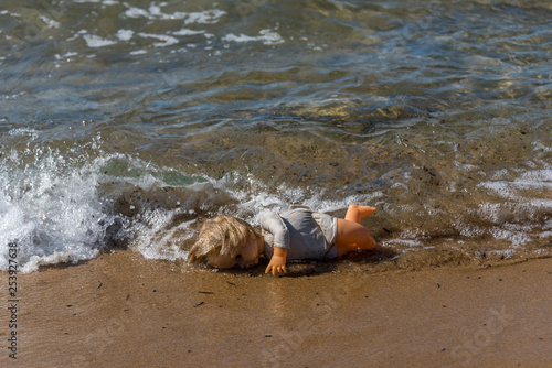 Old Doll Washing Ashore on a Mediterranean Beach