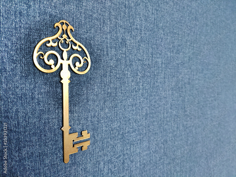 golden key on blue background