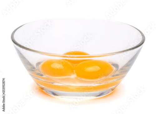 Obraz na plátně three egg yolk in a glass bowl isolated on white background with clipping path