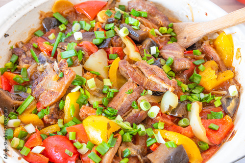 Stew with pork, eggplants, tomatoes and multicolored peppers close-up