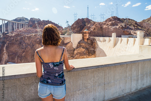 Young woman is admiring the Colorado River from the Hoover Dam in Nevada / Arizona, United States of America