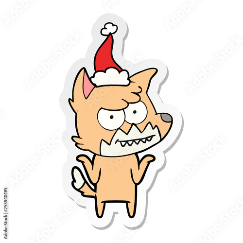 sticker cartoon of a grinning fox wearing santa hat