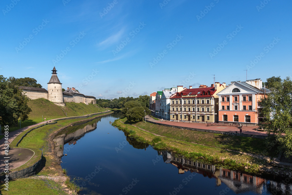 The Golden Embankment and the Pskov Kremlin on the Velikaya River on a sunny summer day. Pskov. Russia