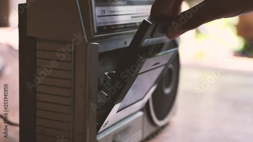 man push play button on a retro music player