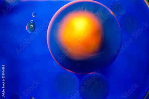 orange ball in orange ring on blue background