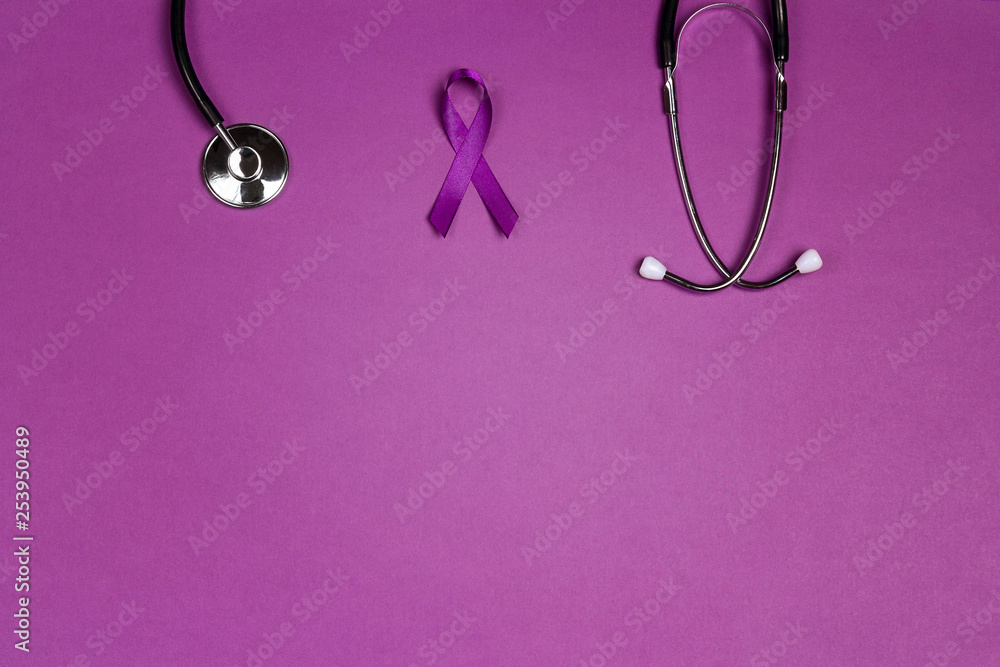 Fototapeta premium Purple epilepsy awareness ribbon with stethoscope and copy space on a purple background.