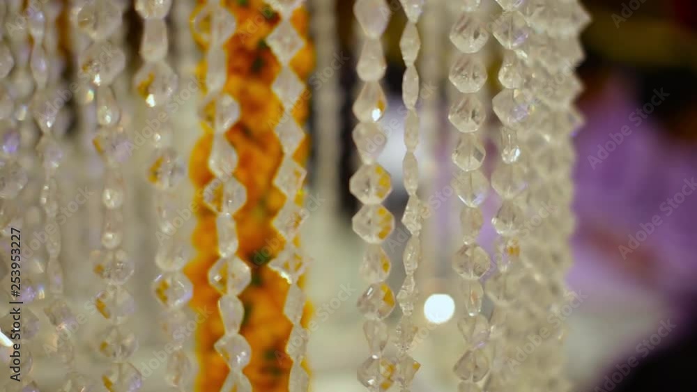 Crystal Clear Acrylic Bead Hanging wedding supplies Line Chain around marry gold flowers, Close Up Crystal Clear Acrylic Bead Hanging wedding supplies Line Chain around marry gold flowers, Close Up