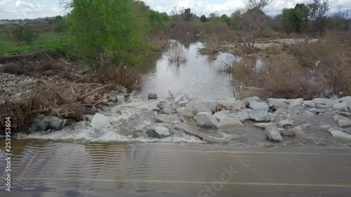 Flood water flowing over a bike path in Whittier Narrows recreation area. photo