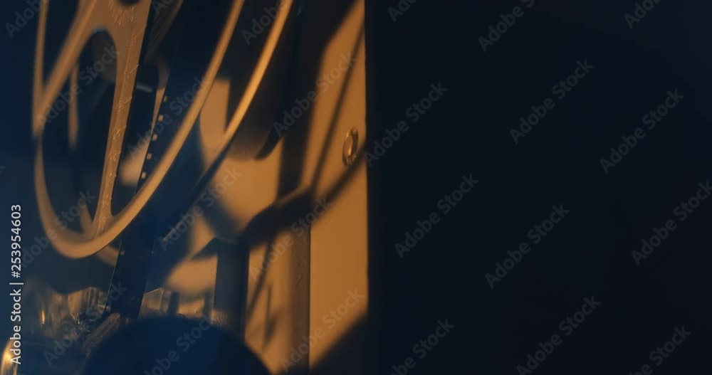 Film runs through an 8mm projector. Closeup on film. Film runs through an 8mm projector. Closeup on film.