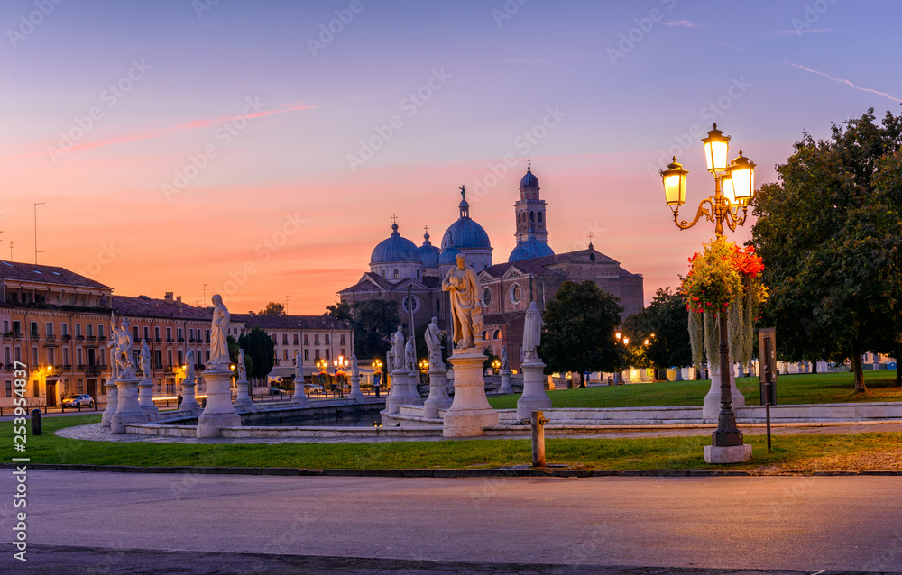 View of canal with statues on square Prato della Valle and Basilica Santa Giustina in Padova (Padua), Veneto, Italy.