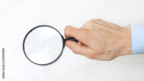 closeup. magnifier in the hand of businessman.