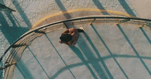 Aerial cenital plane shot, of a boxer training in Tijuana beach. photo