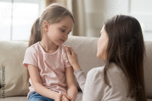 Vászonkép Loving mom talking to upset little child girl giving support