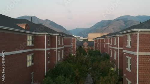 Flying Drone between buildings at Utah State University at Dusk photo