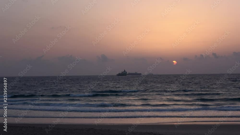Various shots of Getares beach in Algeciras Spain at sunrise. Stunning Mediterranean sea. Ships and ferries crossing. Fisherman at the shore. Dog with owner walking. Various shots of Getares beach in Algeciras Spain at sunrise. Stunning Mediterranean sea. Ships and ferries crossing. Fisherman at the shore. Dog with owner walking.