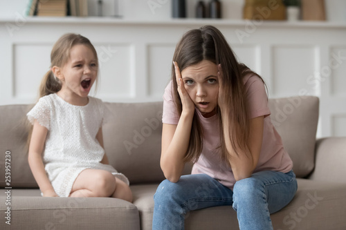 Stressed mother feeling desperate about screaming stubborn kid daughter tantrum