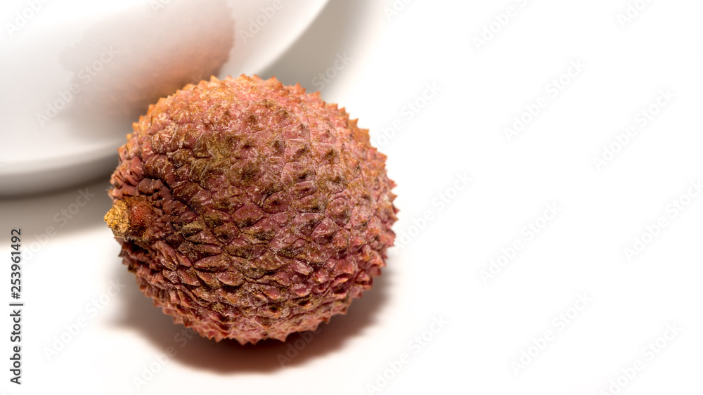 Single lychee fruit, against a white background, detail-taking Single lychee fruit, against a white background, detail-taking