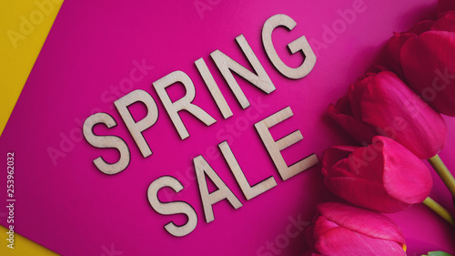 Spring sale banner with pink tulips on colorful background