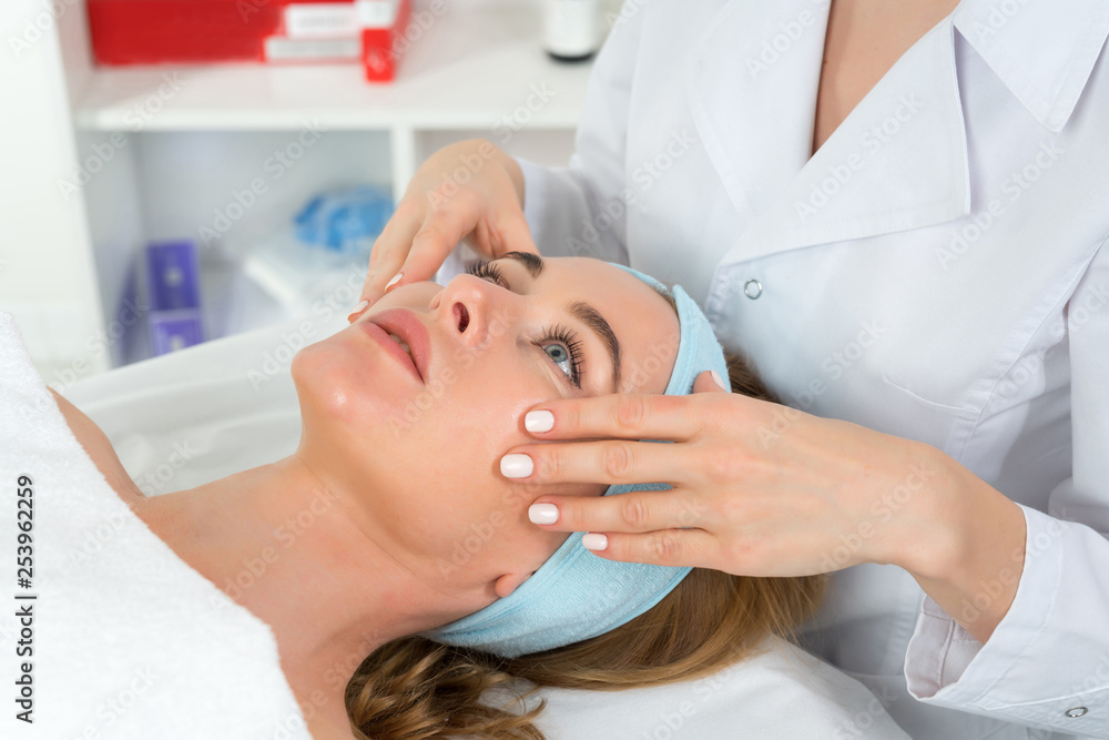 Female beautician doctor with patient in wellness center. Professional cosmetologist make procedure to beautiful girl in cosmetology cabinet or beauty parlor. Female beautician doctor with patient in wellness center. Professional cosmetologist make procedure to beautiful girl in cosmetology cabinet or beauty parlor.