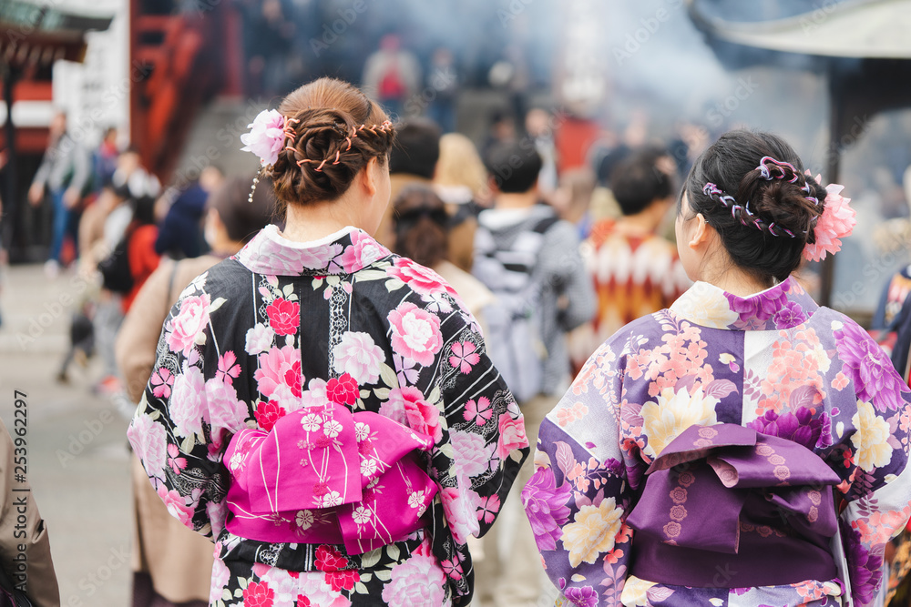 Young girl wearing Japanese kimono standing in front of Sensoji Temple in Tokyo, Japan. Kimono is a Japanese traditional garment. The word 