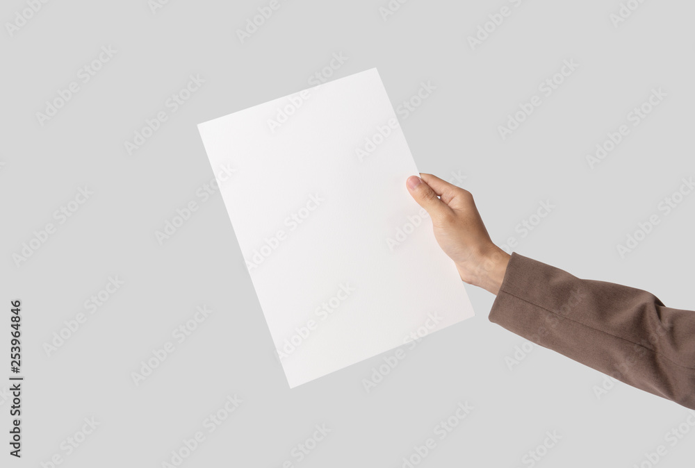 hand showing blank paper A4 flyer for mockup template logo branding on grey background. hand showing blank paper A4 flyer for mockup template logo branding on grey background.