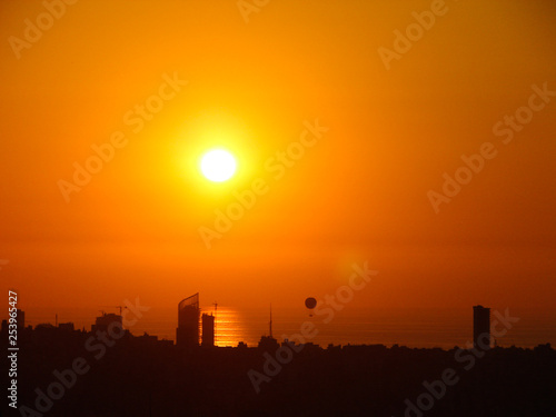 This is a capture of the sunset in Beirut capital of Lebanon with warm orange color, taken in summer 2006 and you can see Beirut downtown in the foreground.