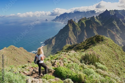 Woman hiker watching beautiful costal scenery. - Tenerife, Canary Islands,  Spain. Western coast view, mountain Anaga photo