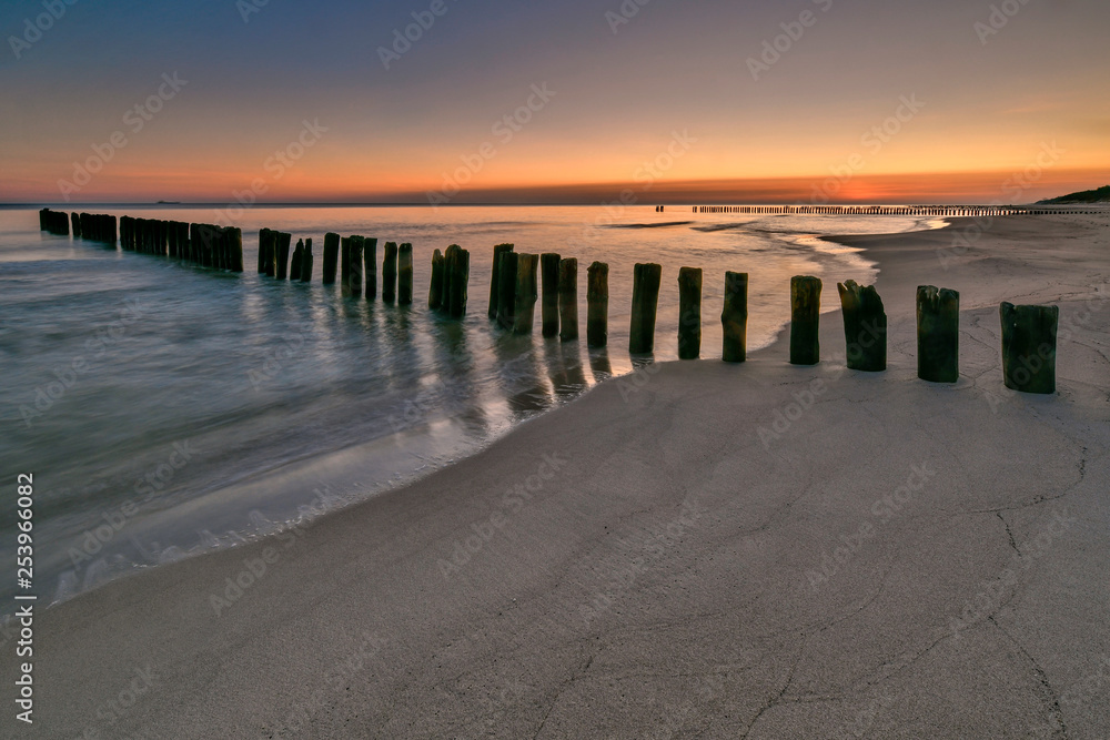 Beautiful sandy beach with a wooden breakwater, Baltic Sea, Poland