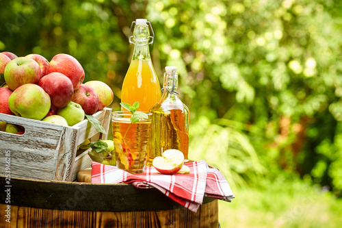 Fényképezés apples on background orchard standing on a barrel