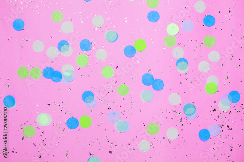 Pink confetti background. Top view, flat lay. Vibrant and festive