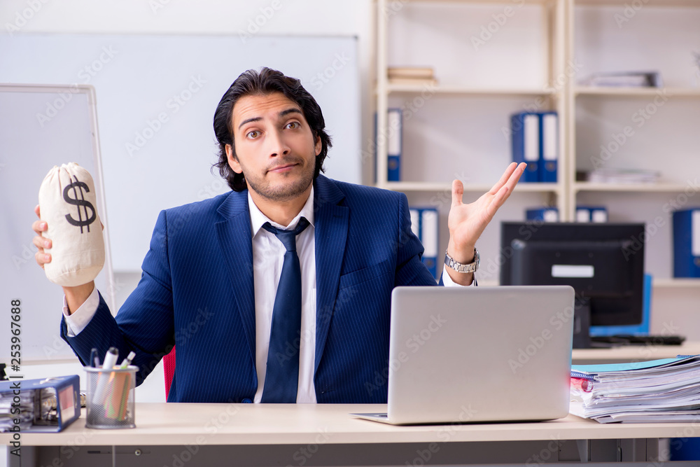 Young handsome businessman working in the office Young handsome businessman working in the office