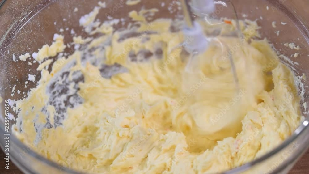 Whipping butter cream in a bowl. Whipping butter cream in a bowl.