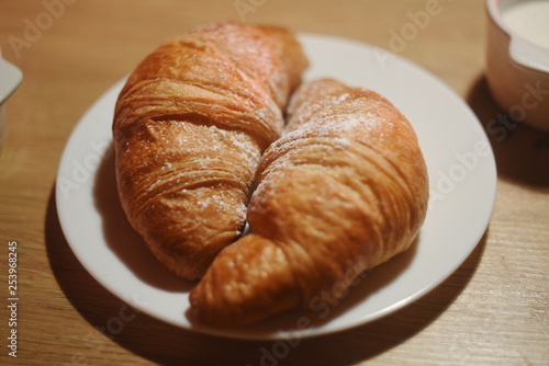 Croissants on a plate on a wooden table. Homemade croissants