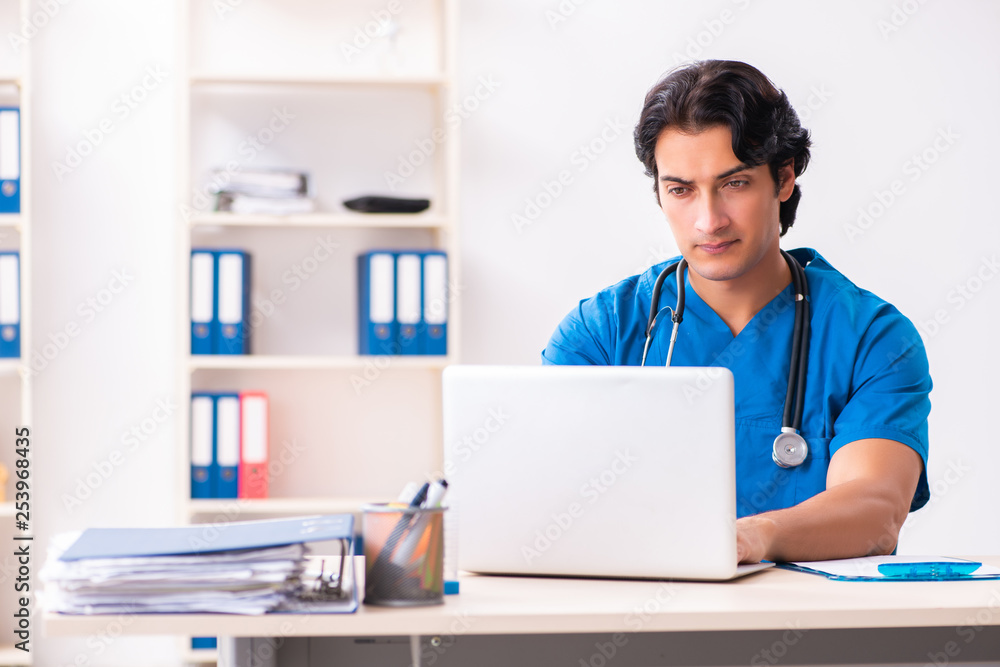 Young handsome doctor working at the clinic Young handsome doctor working at the clinic