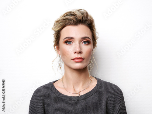 Portrait of beautiful elegant girl with blond hair, trendy styling, beautiful makeup, glossy, smooth skin posing for makeup artist social network portfolio