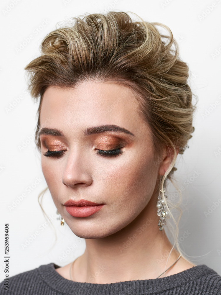 Portrait of beautiful elegant girl with blond hair, trendy styling, beautiful makeup, glossy, smooth skin posing for makeup artist social network portfolio Portrait of beautiful elegant girl with blond hair, trendy styling, beautiful makeup, glossy, smooth skin posing for makeup artist social network portfolio