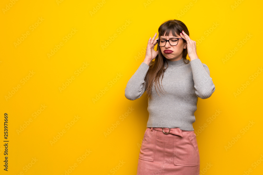 Woman with glasses over yellow wall unhappy and frustrated with something Woman with glasses over yellow wall unhappy and frustrated with something