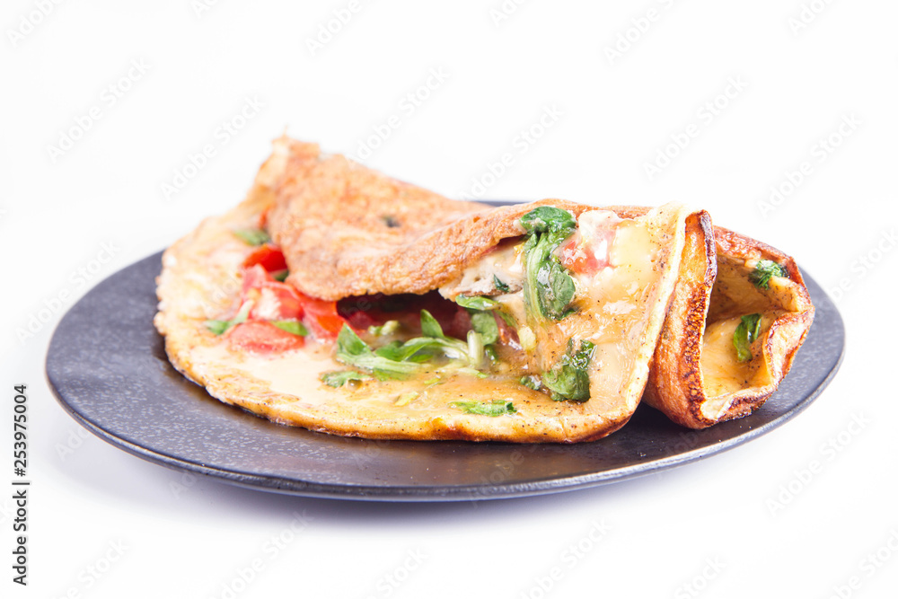 Omelette with tomatoes and fresh corn salad on a white background Omelette with tomatoes and fresh corn salad on a white background