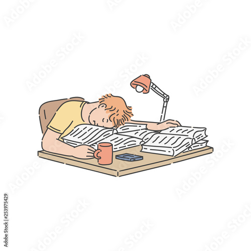 Tired student boy falling asleep on pile of books and papers on table while reading and studying.