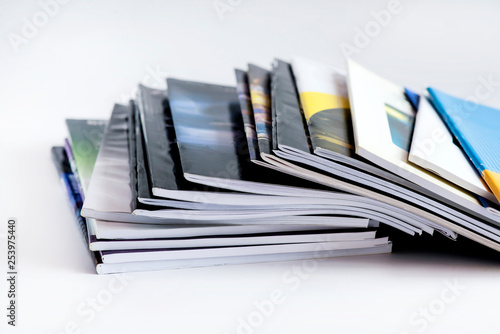 Pile of advertising magazines on a white background. photo