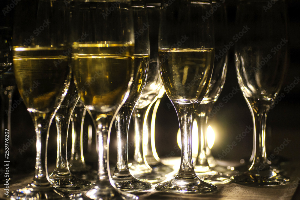 close up photo of glasses of champagne in the dark on the table