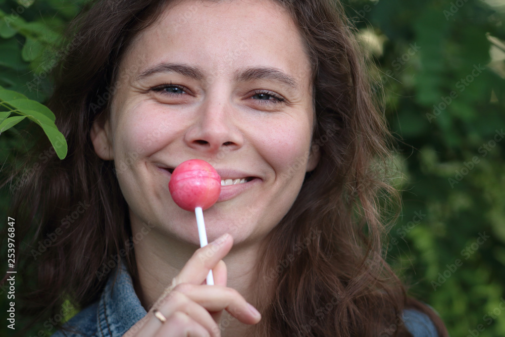 The girl sucks chupa chups. Young woman with Sweet Candy. The girl sucks chupa chups. Young woman with Sweet Candy.