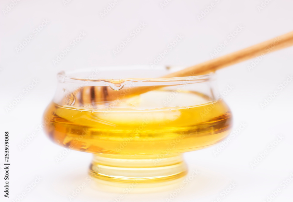 Honey pot and dipper isolated on white background, copy text Honey pot and dipper isolated on white background, copy text