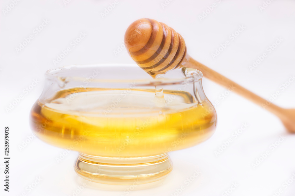 Honey pot and dipper isolated on white background, copy text
